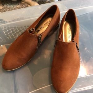 Tan flat shoes with side zippers, size 8.
